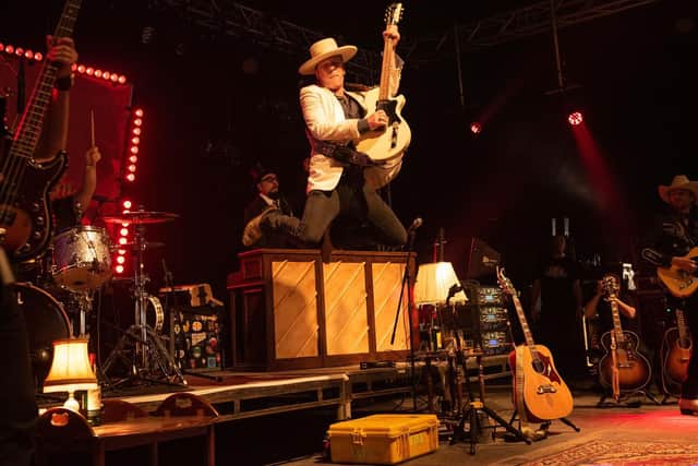 Kiefer Sutherland and his band perform on The Village Stage. Pictured is Kiefer leaping from the stage riser. Picture: Vernon Nash (040819-002)