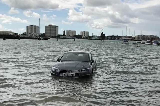 The Audi was spotted in the water at Portsmouth Harbour after the tide came in at 1.30pm. Picture: Kelly Wright