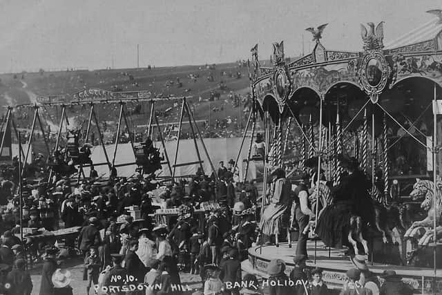With a packed carousel and boat swings we see people enjoying the Bank Holiday funfair on Portsdown Hill in teh 1920s. Photo: Barry Cox postcard collection