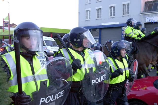 Police confront football hooligans outside Fratton Park following the match against Southampton in 2004. Picture: Malcolm Wells (041492-131)