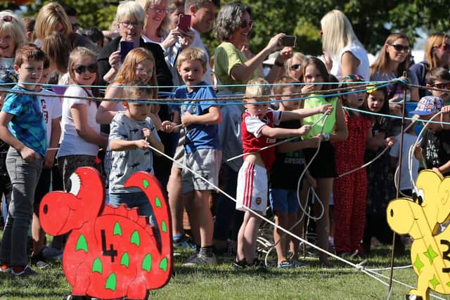 Taking part in the dinosaur race. Dinosaur Derby organised by Denmead Scouts at Kidmore Lane, Denmead. Picture by Chris Moorhouse (080919-37)
