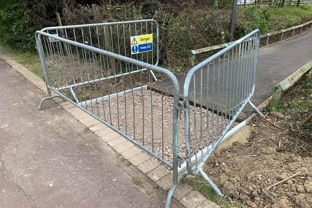 The path after the large metal and wooden fencing was removed and before further paving work earlier this week.