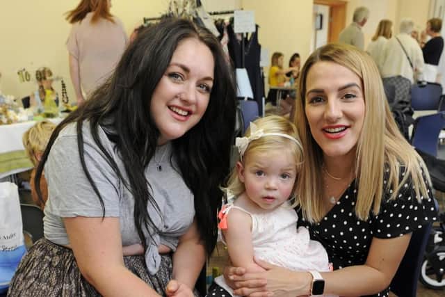 A bowel cancer fair to raise money for research has been held at The Church of the Resurrection in Drayton. From left, Jenny Harrison, Everly Bridger and her mum Laura. Picture: Ian Hargreaves  (140919-2)