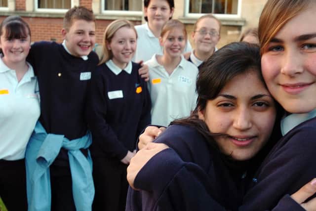 Lorin Sulaiman (14) receives a welcome back hug from best friend Sharon Thomas (14) watched by school friends, Kirsty Squires, Joshua Breach, Jess Randle, Tom Ross, Sarah Monnier, Katie Newell and Kirsty Elstone outside Mayfield School in 2004
