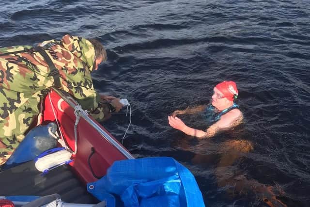 Rosalinda Hardiman takes a food break during her 20-hour swim of Loch Ness.