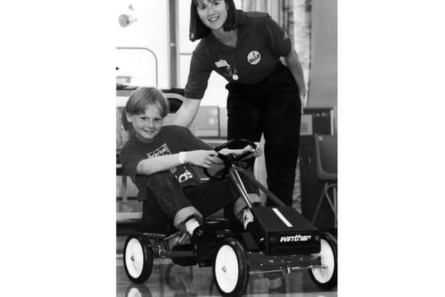 Adam Easton on one of the new pedal cars in June 1994