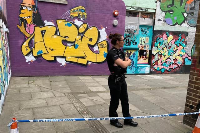 Police at the scene by Palmerston Road after a woman's body was found