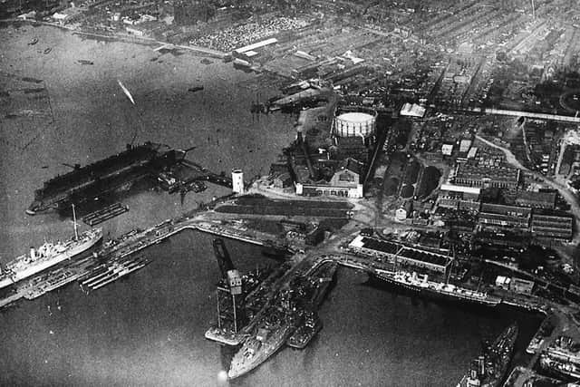 Mighty ships in Portsmouth Dockyard. Battleships, a floating dock, submarines and the the royal yacht Victoria & Albert.