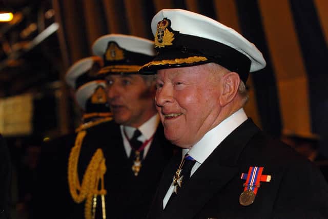 Sir Donald Gosling shares a lighter moment with a member of the ships crew as he inspects the ranks of HMS Ark Royal accompanied by (left) former First Sea Lord Admiral Sir Jonathon Band.
Photo: Malcolm Wells  (071190-108)