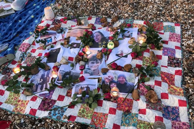 People attending the event at Stokes Bay on World Suicide Prevention Day placed photographs of their loved ones on a special quilt of remembrance which was decorated with candles and flowers