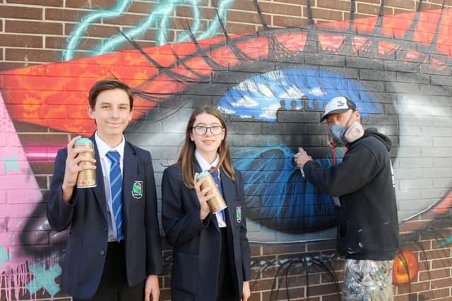 Oscar Williams, 14, Amy Holden, 14, and artist My Dog Sighs.
Picture: Sarah Standing