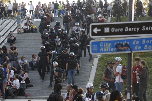French police officers leave the Parc de Bercy after a climate change protest in the French capital Paris on September 21, 2019. - Over a hundred demonstrators were arrested at yellow vest protests in Paris, as about 7,500 police were deployed to deal with the movement's radical anarchist "black blocs" strand. After first marching with the yellow vests, around 1,000 radical demonstrators joined a separate march against climate change where they provoked clashes with police, authorities said. (Photo by Zakaria ABDELKAFI / AFP)