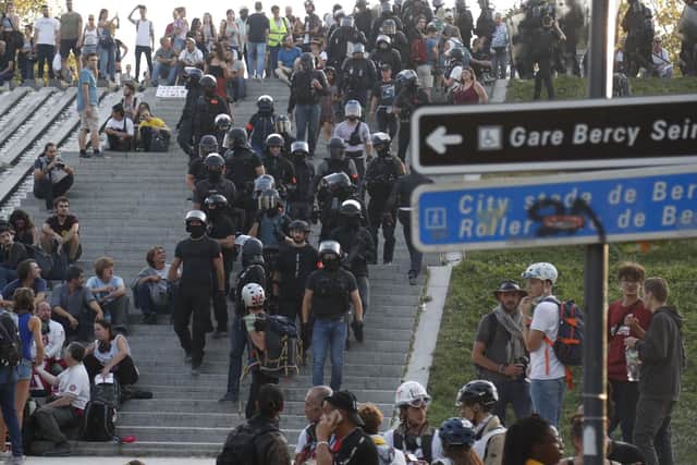French police officers leave the Parc de Bercy after a climate change protest in the French capital Paris on September 21, 2019. - Over a hundred demonstrators were arrested at yellow vest protests in Paris, as about 7,500 police were deployed to deal with the movement's radical anarchist "black blocs" strand. After first marching with the yellow vests, around 1,000 radical demonstrators joined a separate march against climate change where they provoked clashes with police, authorities said. (Photo by Zakaria ABDELKAFI / AFP)