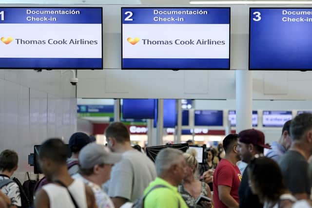 Stranded tourists line up in front of the Thomas Cook counter at the Cancun airport in Mexico. Picture: AP Photo/Victor Ruiz