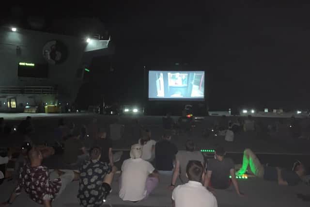 HMS Queen Elizabeth's crew enjoy a movie night of mega proportions as they enjoy a well-earned evening off on Thursday, Seoptember 26. The screening of The Greatest Showman came as the aircraft carrier continued its Westlant 19 deployment off the east coast of the USA. Picture: HMS Queen Elizabeth