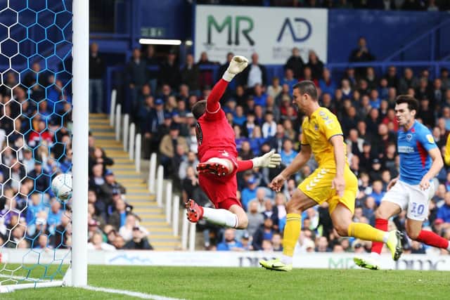 Bolton keeper Remi Matthews cannot prevent Brett Pitman's header from entering the net in Pompey's 1-0 win. Picture: Joe Pepler