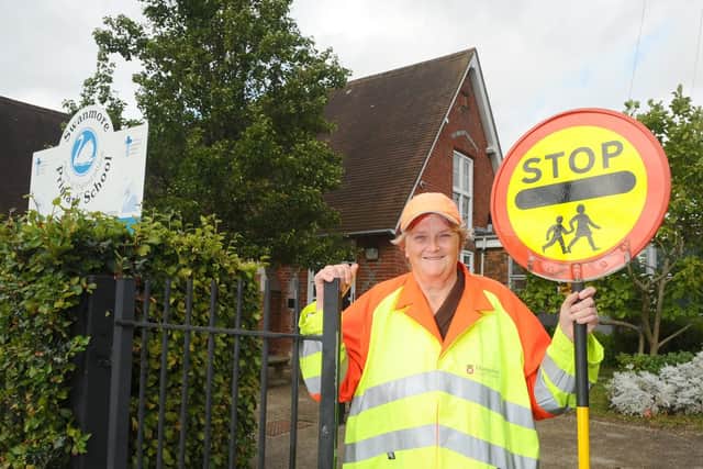 Lollipop lady Judy Cook is celebrating 25 years of helping children get to school safely, outside Swanmore C of E Primary School on Church Road, Swanmore. Picture: Sarah Standing (270919-7638)