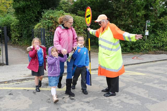Judy Cook helps Helen Lyons-Walters, 40, rom Swanmore with her children Evie-Rose Lyons-Walters, seven, Faye Lyons-Walters, four, and Dominic Lyons-Barlow, eight. Picture: Sarah Standing (270919-7682)