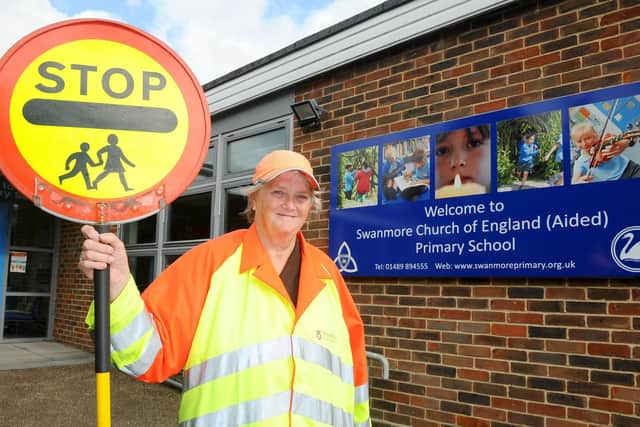 Lollipop lady Judy Cook is celebrating 25 years of helping children get to school safely, outside Swanmore C of E Primary School in Church Road, Swanmore. Picture: Sarah Standing (270919-7635)