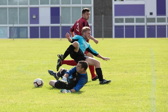 Horndean keeper Paul Charlton rushes out to clear