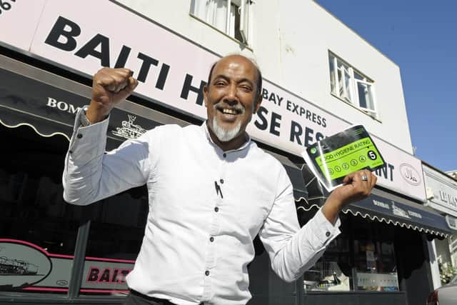 Babul Miah celebrates after earning his first ever five star hygiene rating at his restaurant, the Bombay Express Bali in Southsea. Picture: Ian Hargreaves  (010919-1)