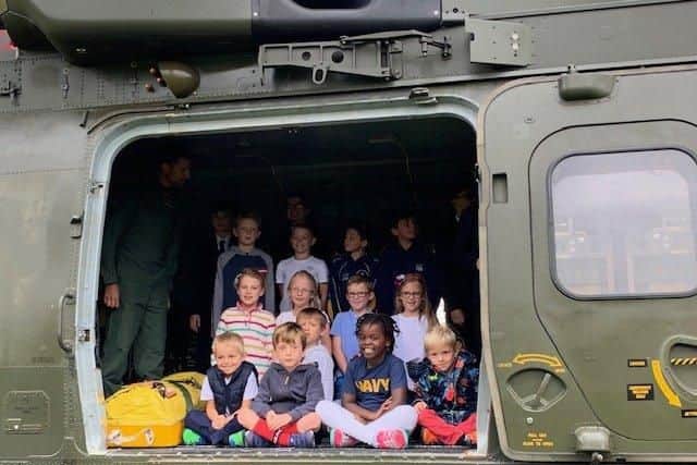 Children from Crofton Hammond Infant School on board a Royal Navy helicopter which landed in their school field.
