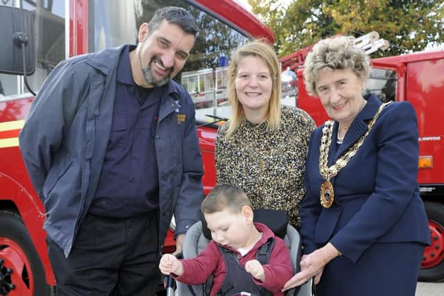 Portchester firefighters have staged a celebration at their station for recipients of money they collected from their Christmas fundraising events. Nicola Montague with her son Finlay (four), with Paul Strong of the Fire Engine Preservation Group and the Mayor of Fareham Councillor Pamela Bryant. Picture: Ian Hargreaves  (061019-8)