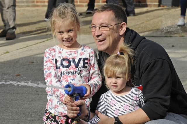 Portchester firefighters have staged a celebration at their station for recipients of money they collected from their Christmas fundraising events. Firefighter Simon Hart with children Marlee (five), and Zoey (two).Picture: Ian Hargreaves  (061019-7)