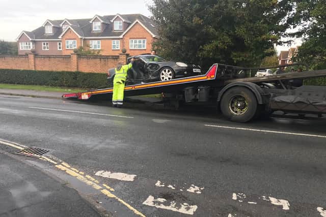 The damaged vehicle is taken away.