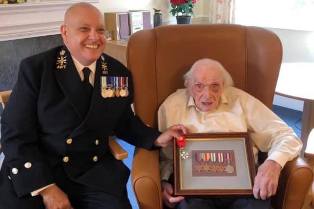 Reg Tegg pictured receiving a birthday surprise from the Royal Engineers Association to mark his 101st birthday in June. He is pictured with nephew, Martin Oates, who is a Chief Petty Officer in the Royal Navy.