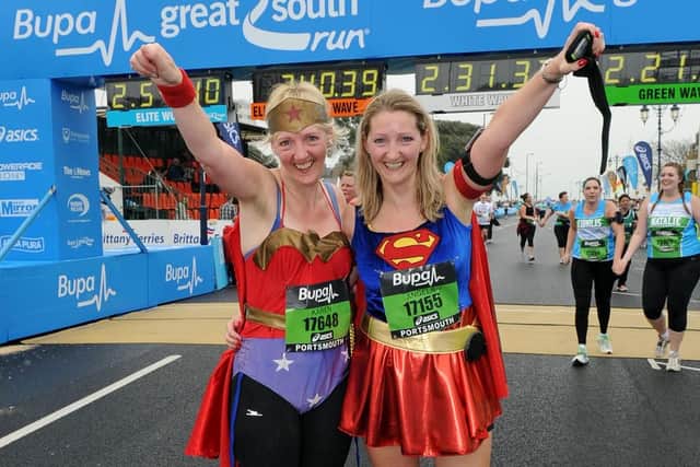 Karen Chambers as Wonder Woman and her running partner Angela Mays as Super Girl from Petersfield cross the Finish Line in 2011. Picture: Malcolm Wells (113863-5061)