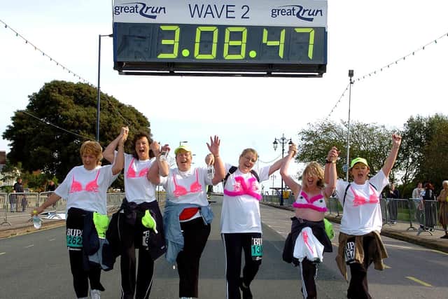 The last runners to cross the finish line in the Great South Run 2004. (l-r) Pauline Peach (39), Penny Beven (50), Debbie Moss (44), Sam read (36), Sue Juriansz (44) and Carol Gibson (45), running for Breast cancer 'Walk the Walk'. Picture: Matt Scott-Joynt (044993-264)