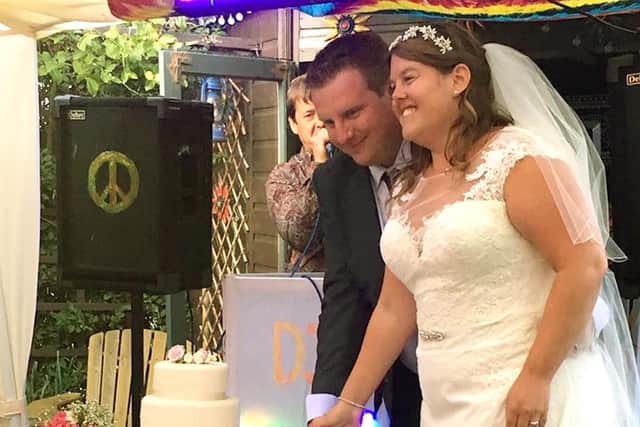 The happy couple cut their wedding cake.