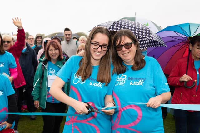 (L-R) Hannah Woods with her mother Juliet cut the tape to lead off the Memory Walk. Picture: Duncan Shepherd