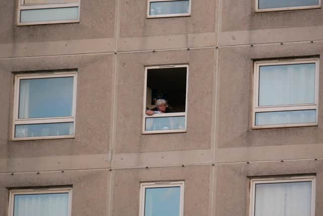 A resident looks from their window in Tipton House, Warwick Crescent, Somers Town, Portsmouth, after reports of a chemical incident at the building. Picture: Habibur Rahman