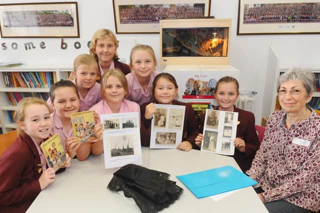 Meg Arthers, Thea Carpenter, and Jessica Cox with (front row left to right) Matilda Roberts, Libby Crane, Isobel Dancey, Sophie Meyer, and Rosie Auckland, all aged 10, learn about recipes from the past with with Diana Holland, 76.
Picture: Sarah Standing