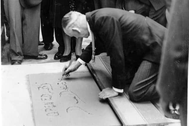 Lord mayor Sir Denis Daly signs his name in concrete at the opening of the Municipal Restaurant July 17, 1941. Picture: Pat Daly collection.