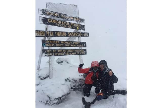Amputee Lance Smith doing the splits at the summit after he successfully climbed Kilimanjaro
