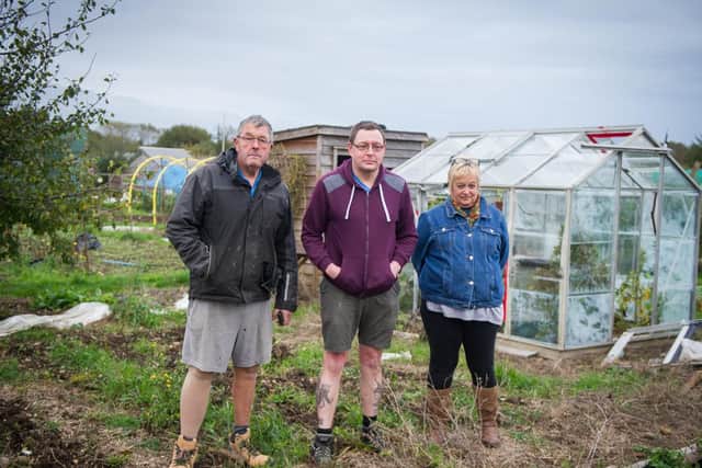Gardeners Geoff Pescud, Matt Redsull and Karen Standen in front of a greenhouse smashed by vandals. Picture: Habibur Rahman
