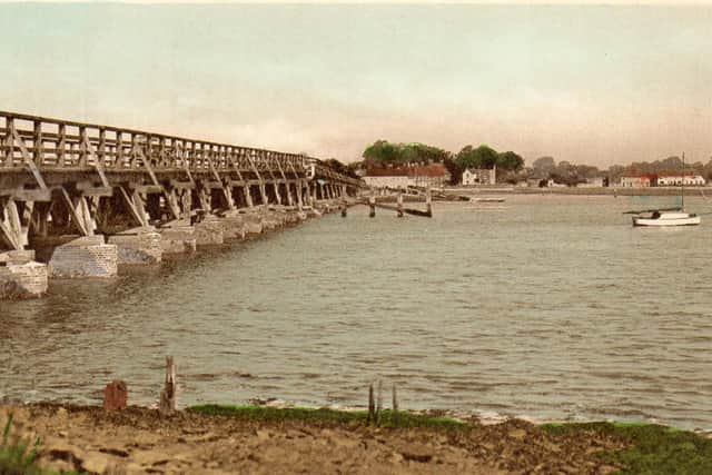 A hand-tinted photograph of the wooden Langstone Bridge. Picture: Ralph Cousins's collection.