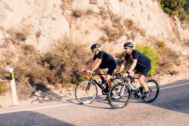 Andy McGhee and a member of his support team cycling in Spain.