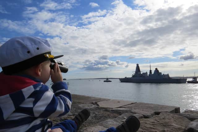 Harry Sharkey watching his Dad,Lieutenant CommanderPhilip Sharkey, sail out of Portsmouth on deployment