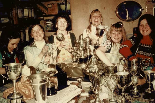 Girls from Southsea Modern School Folk Dance Club cleaning some of the 171 trophies for the 1973 Portsmouth Music Festival. Picture: The News archive/Mick Cooper collection