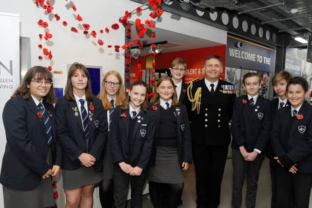 Commodore JJ Bailey, commander of Portsmouth Naval Base with children from Portchester Community School, who attended the Poppy Appeal launch. Picture: Sarah Standing (251019-196)