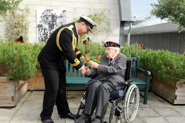 Commodore JJ Bailey presents a ceremonial poppy to Polish veteran Colonel Otton Hulacki. Picture: Sarah Standing (251019-176)