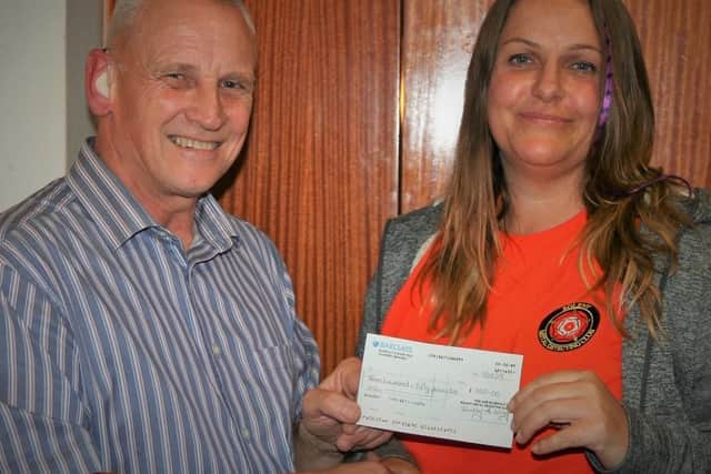 Andrew Coombs from Solent Metal Detecting Club presenting Laura Harris with a donation from members towards her treatment for Lyme disease