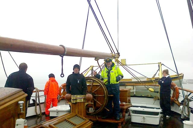 Harbourmaster Ben McInnes steering the tallship Georg Stake into harbour