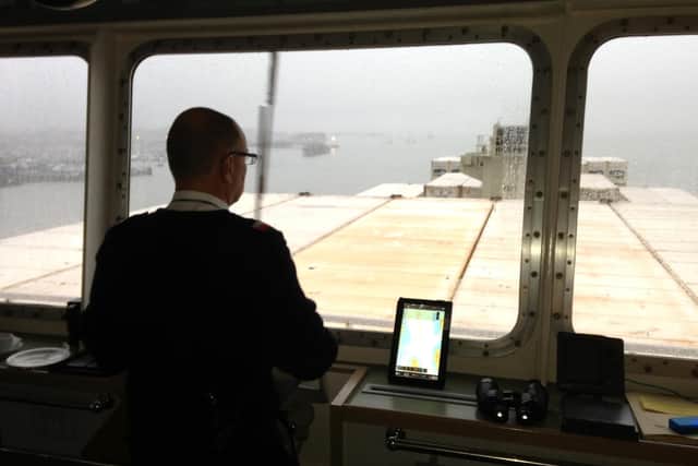 Pilot Nick Hardesty guides a container ship into harbour