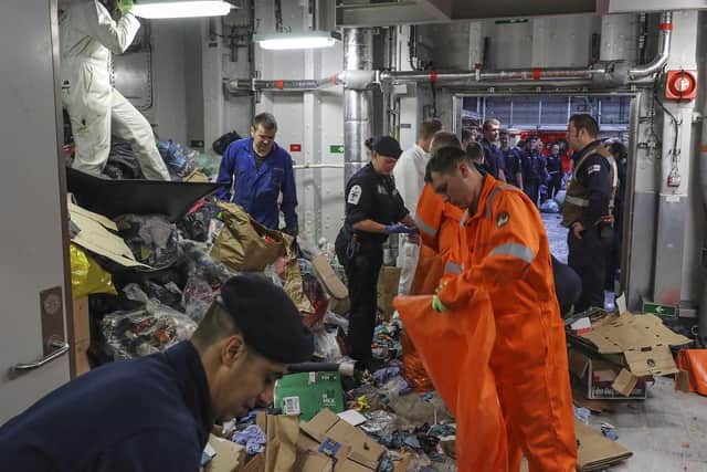 HMS Queen Elizabeth ordered a clear lower deck (calling all ship's company) to gather in the hanger for out all gash - rubbish.