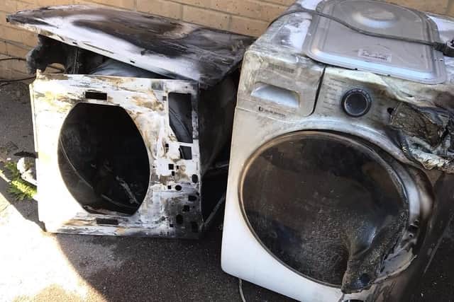 The remains of the charred tumble dryer.